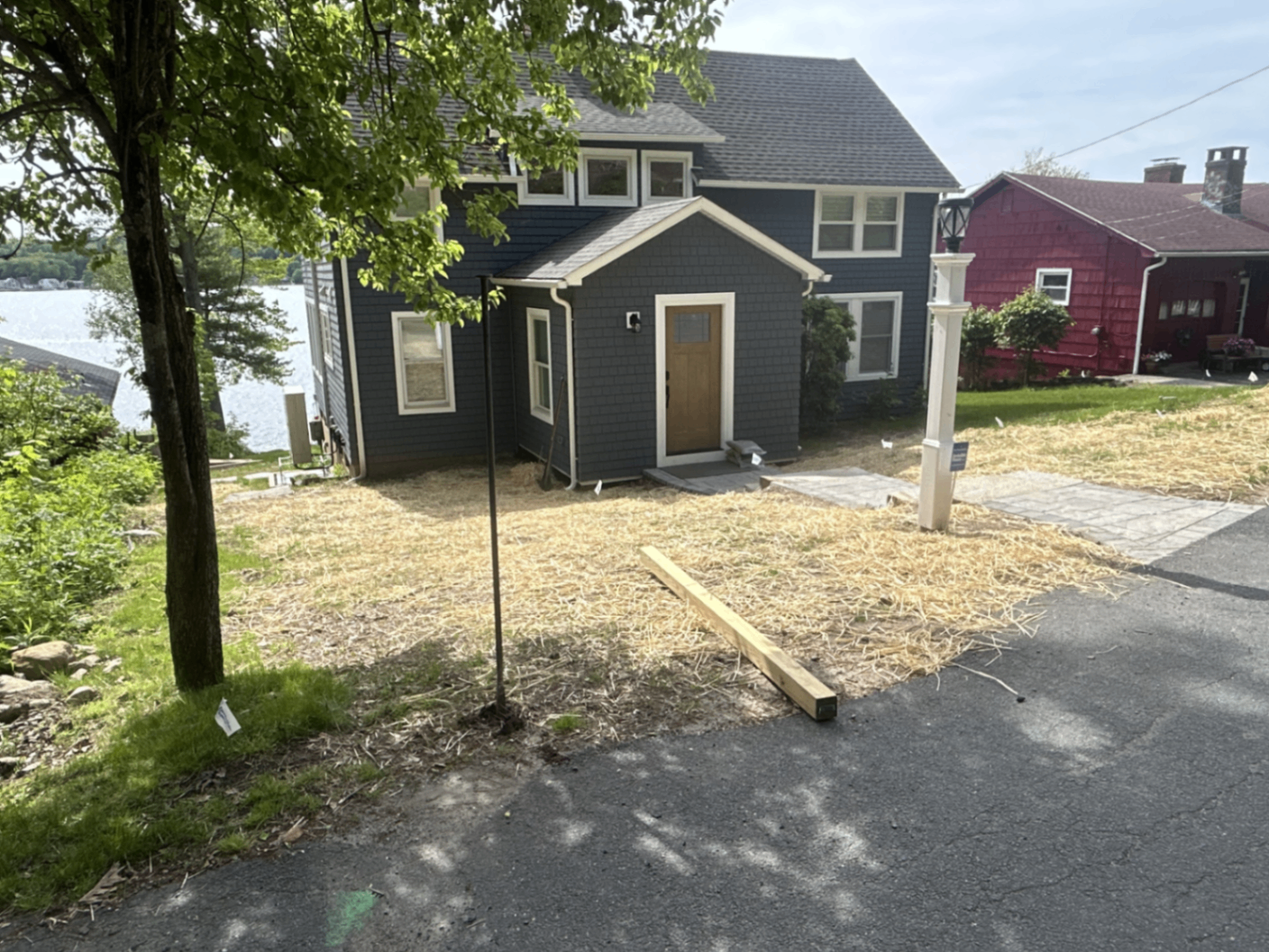 Renovated navy shingled lake house with new gabled entry porch