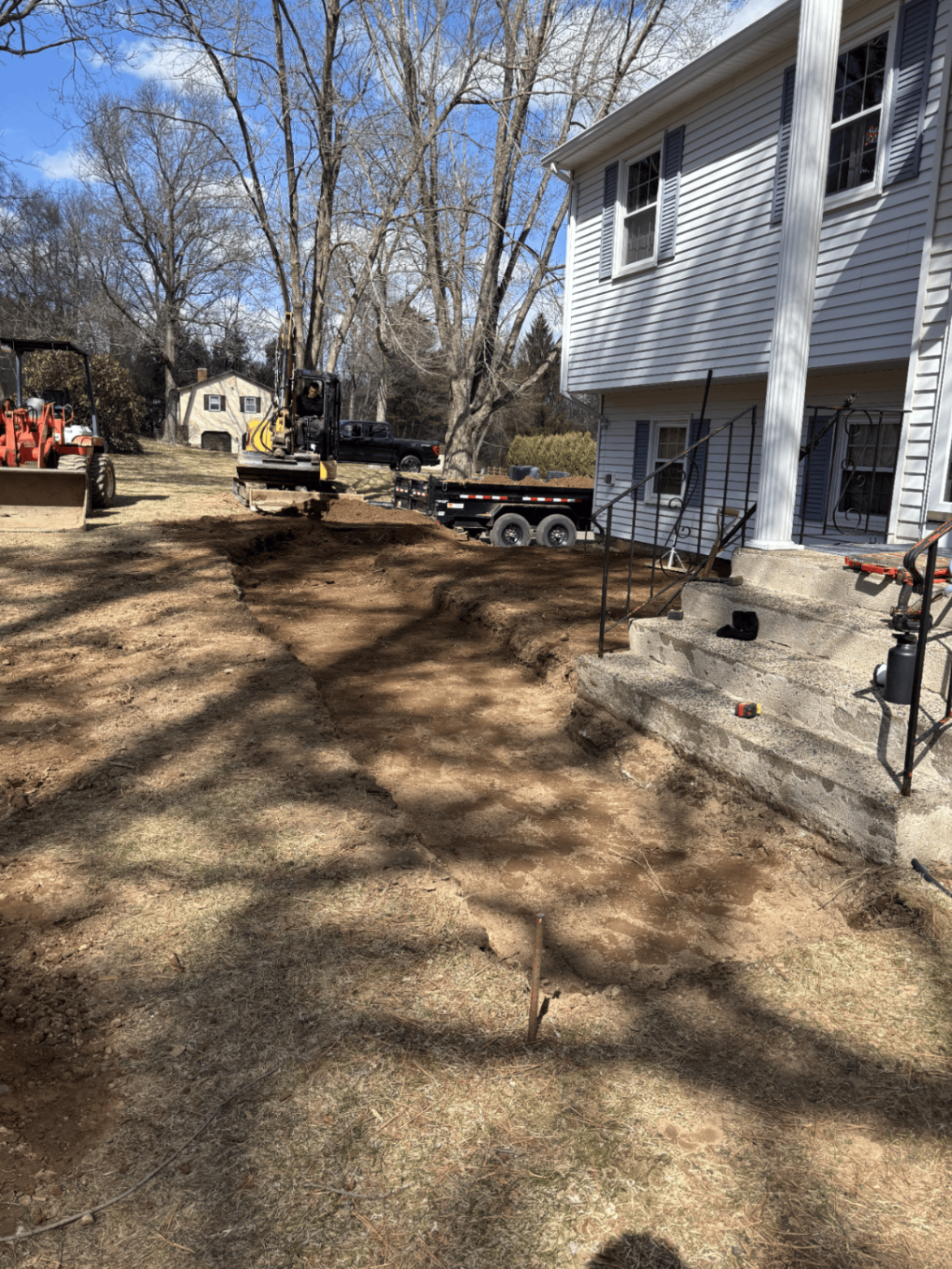 Front yard excavated and graded before paver walkway installation