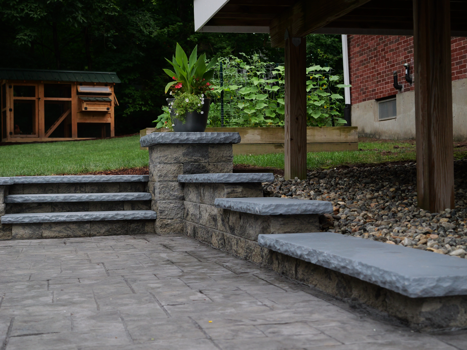 Backyard stone patio with built-in steps and seating