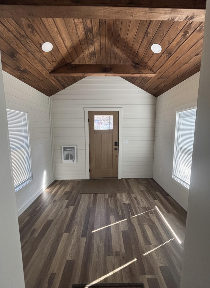 Interior entry with vaulted shiplap ceiling and wood plank floor