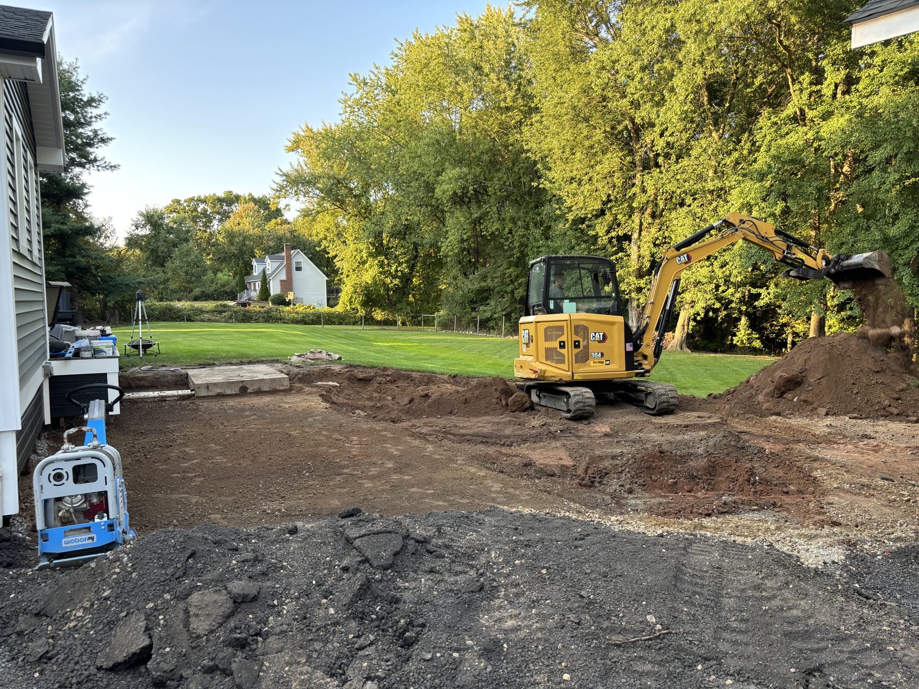Backyard excavated and graded before patio installation